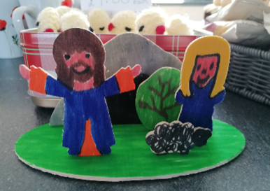 Colourful cardboard cutout Jesus figure with sheep and person