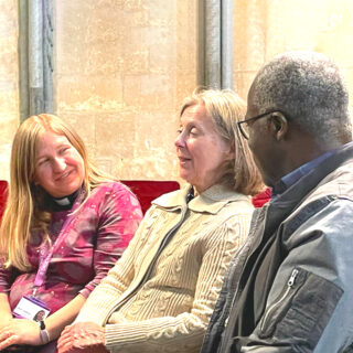 Three people talking in a church